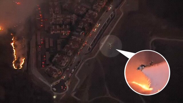 Helicópteros lançam água para impedir avanço de fogo sobre bairro de celebridades em Los Angeles